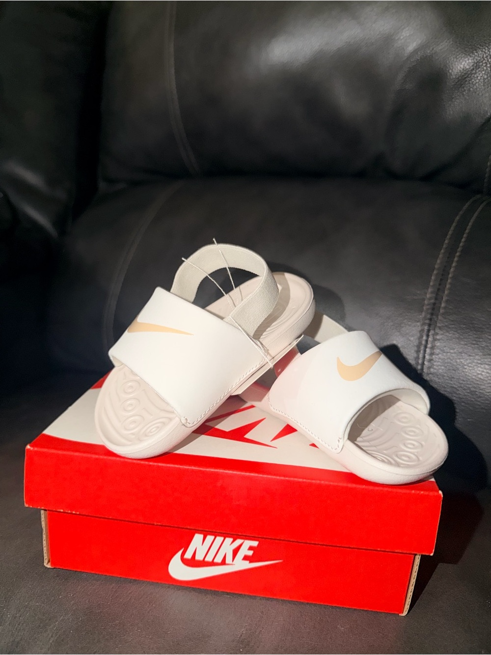 Nike Kids White Slide Sandals with Gold Swoosh Accent